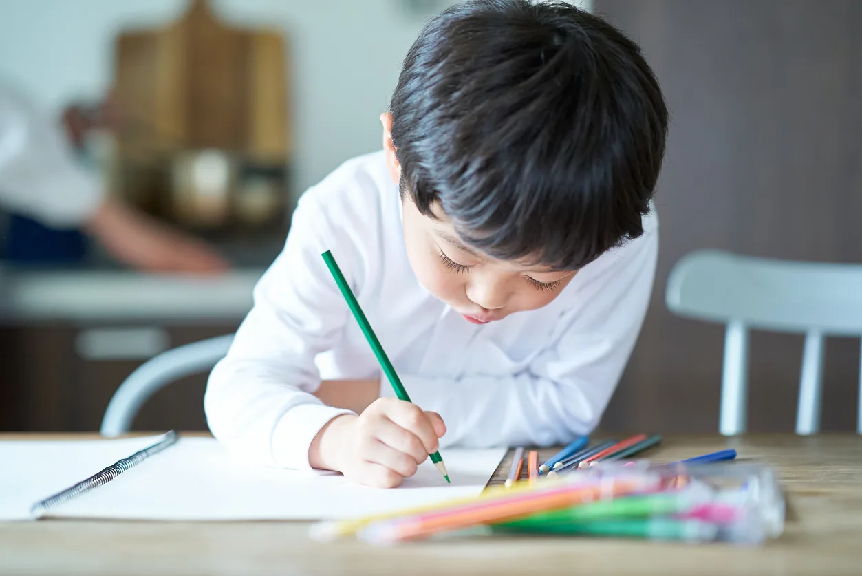 A child concentrating on a drawing