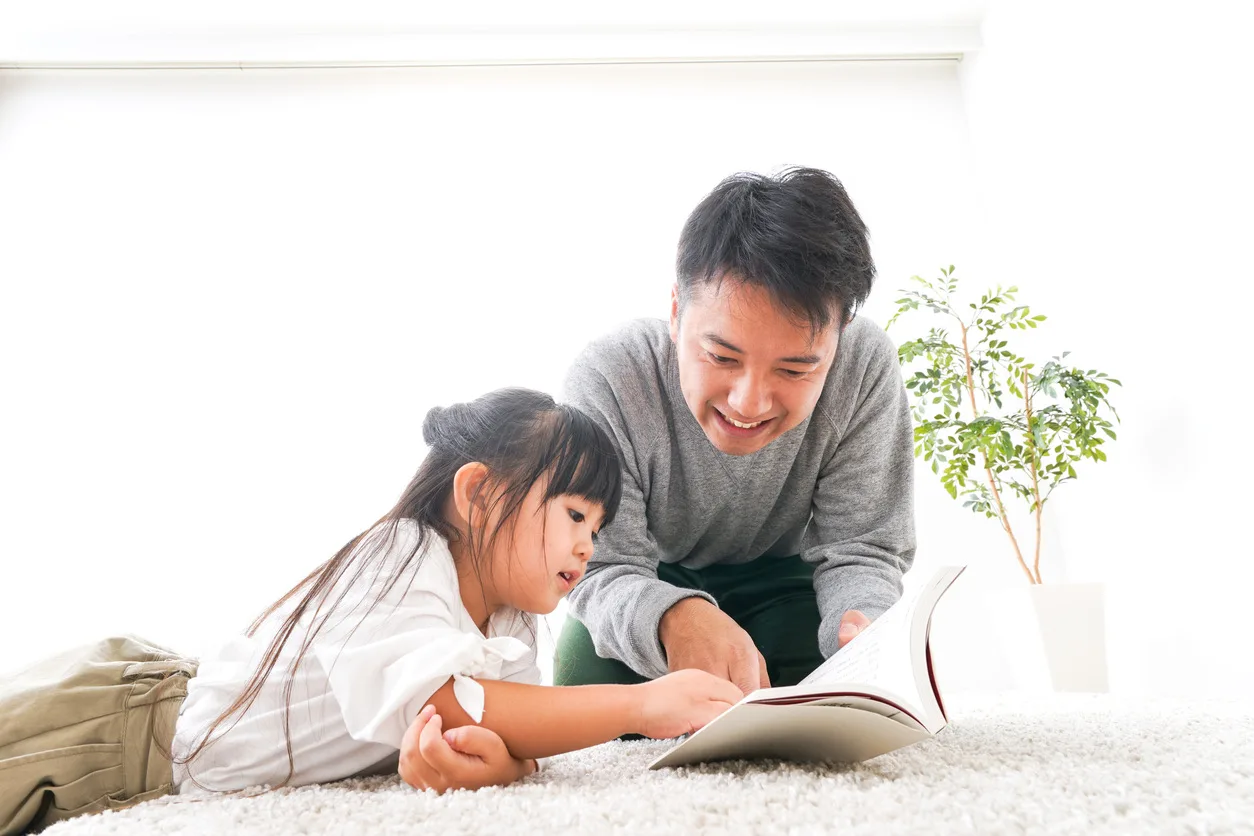 Father reading a book to his child